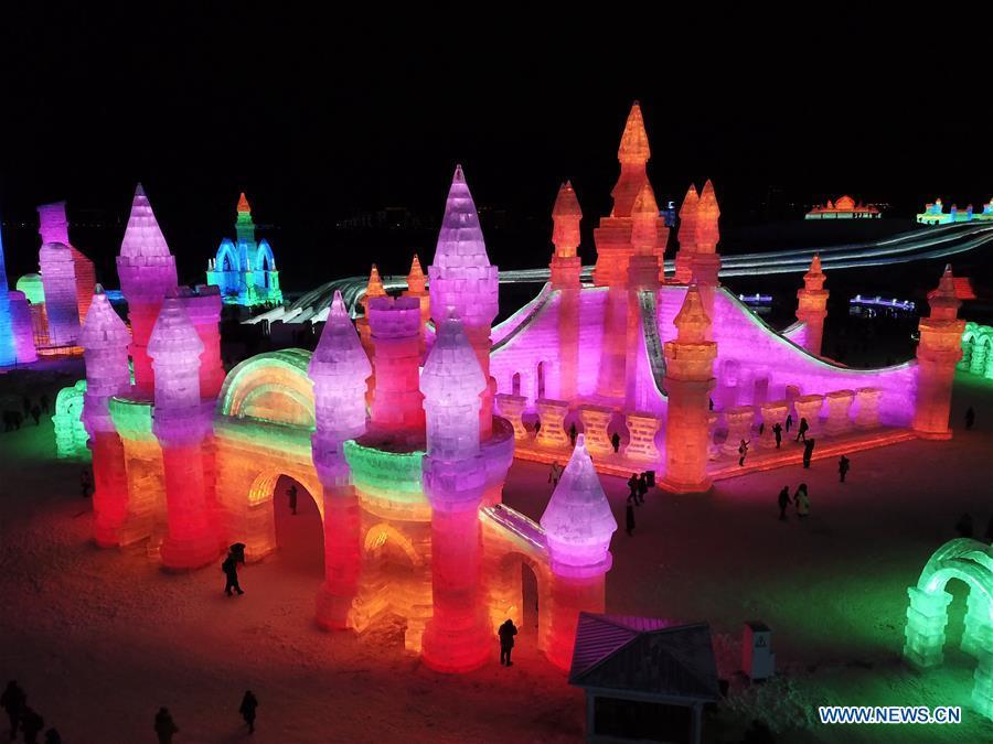 Tourists visit the Ice-Snow World in Harbin, capital of northeast China\'s Heilongjiang Province, Dec. 23, 2018. The Ice-Snow World opened on Sunday in Harbin. Covering an area of 600,000 square meters, the park used 110,000 cubic meters of ice and 120,000 cubic meters of snow this year. (Xinhua/Wang Song)