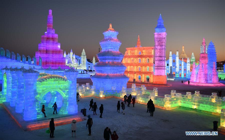 Tourists visit the Ice-Snow World in Harbin, capital of northeast China\'s Heilongjiang Province, Dec. 23, 2018. The Ice-Snow World opened on Sunday in Harbin. Covering an area of 600,000 square meters, the park used 110,000 cubic meters of ice and 120,000 cubic meters of snow this year. (Xinhua/Wang Jianwei)