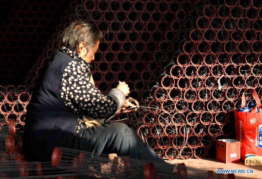 A worker makes red lanterns in Tuntou Village, Gaocheng District, Shijiazhuang City, north China\'s Hebei Province, Dec. 23, 2018. As the New Year approaches, lantern craftsmen in Gaocheng, which is known for its lantern manufacturing, are busy making red lanterns. (Xinhua/Chen Qibao)