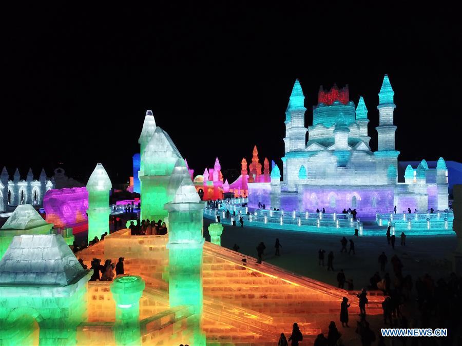 Tourists visit the Ice-Snow World in Harbin, capital of northeast China\'s Heilongjiang Province, Dec. 23, 2018. The Ice-Snow World opened on Sunday in Harbin. Covering an area of 600,000 square meters, the park used 110,000 cubic meters of ice and 120,000 cubic meters of snow this year. (Xinhua/Wang Song)