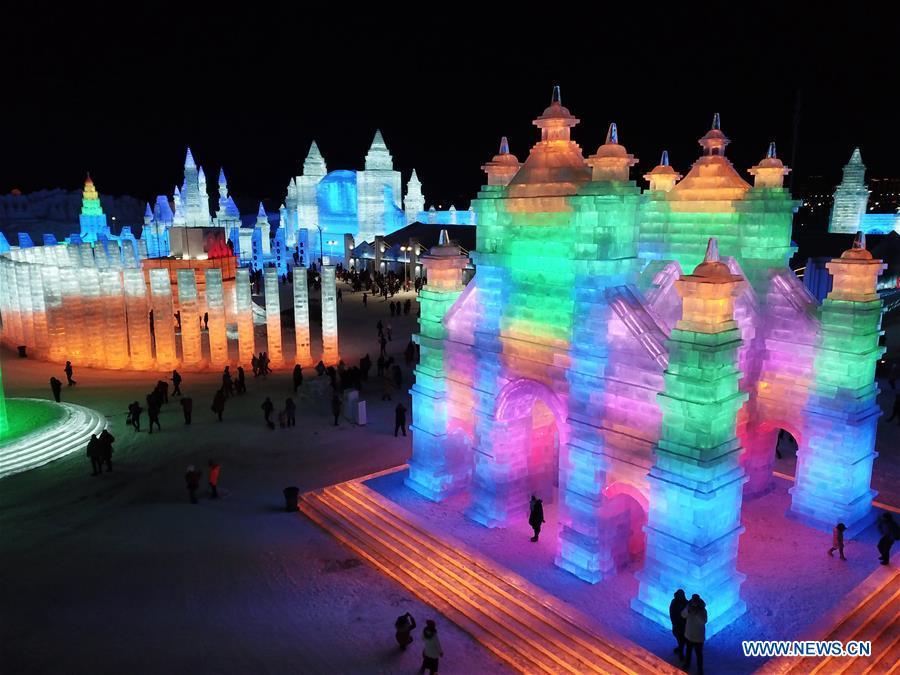 Tourists visit the Ice-Snow World in Harbin, capital of northeast China\'s Heilongjiang Province, Dec. 23, 2018. The Ice-Snow World opened on Sunday in Harbin. Covering an area of 600,000 square meters, the park used 110,000 cubic meters of ice and 120,000 cubic meters of snow this year. (Xinhua/Wang Song)