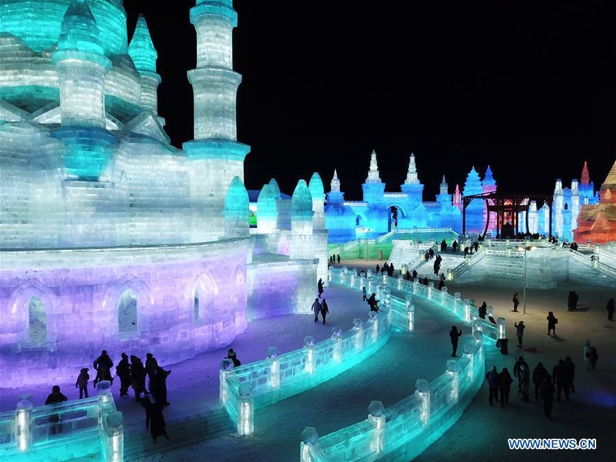 Tourists visit the Ice-Snow World in Harbin, capital of northeast China\'s Heilongjiang Province, Dec. 23, 2018. The Ice-Snow World opened on Sunday in Harbin. Covering an area of 600,000 square meters, the park used 110,000 cubic meters of ice and 120,000 cubic meters of snow this year. (Xinhua/Wang Song)