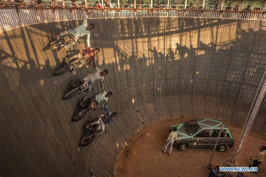 Stuntmen perform on their vehicles in a \