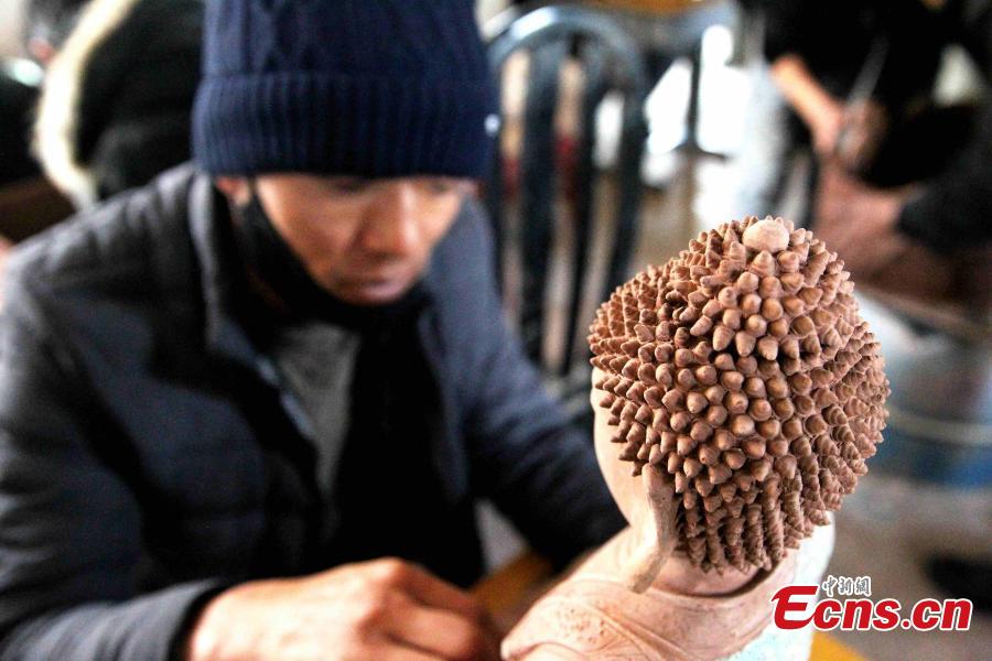 A folk artist creates a clay sculpture in Regong, Tongren County, Huangnan Tibetan Autonomous Prefecture, Qinghai Province, Dec. 25, 2018. Buddhist monks and folk artists carry on the plastic arts of painting thangka and murals, crafting patchwork barbola and sculpting known collectively as the Regong arts, inscribed on the representative list of the UNESCO Intangible Cultural Heritage of Humanity. (Photo: China News Service/Zhang Tianfu)