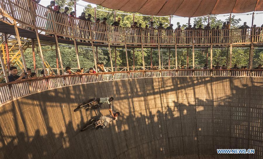 Stuntmen perform on their vehicles in a \