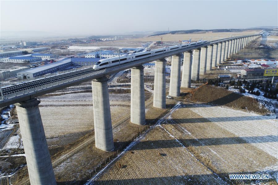 A bullet train runs in the suburbs of Mudanjiang, northeast China\'s Heilongjiang Province on Dec. 25, 2015. A high-speed railway line officially went into operation on Tuesday, linking cities of Harbin and Mudanjiang in China\'s northernmost province of Heilongjiang, where the temperatures dip as low as minus 40 degrees Celsius. (Xinhua/Zhang Chunxiang)