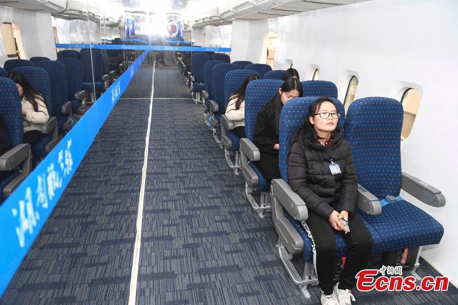 Visitors try out the passenger cabin of an aircraft at the Hunan Aviation Museum at the Changsha Aeronautical Vocational and Technical College in Changsha City, Central China\'s Hunan Province. The museum showcases aviation equipment, aviation technology and culture. It is also the national defense education base of Hunan. (Photo: China News Service/Yang Huafeng)
