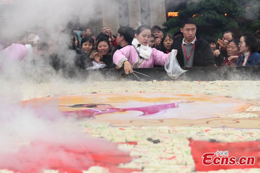 A steamer measuring eight meters in diameter and weighing two tons is used to cook sponge cake at a scenic area in Yichun City, East China\'s Jiangxi Province, Dec. 27, 2018. More than 88,000 pieces of cake were made and offered to tourists for free, along with wishes for success. The number 8 is considered lucky in Chinese culture because the pronunciation of \'eight\' in Mandarin Chinese is close to that of the phrase meaning \'to make a fortune\'. (Photo: China News Service/Chen Fei)