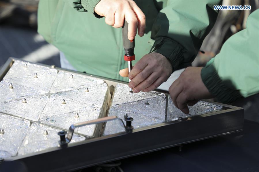 Workers install new crystal triangles on a panel of the New Year\'s Eve Ball during a ceremony on the roof of the One Times Square building in New York City, the United States, on Dec. 27, 2018. The iconic New Year\'s Eve Ball at New York City\'s Times Square had its latest decoration done on Thursday for the upcoming celebrations. For Times Square 2019, 192 Waterford Crystal triangles introduce the new Gift of Harmony design of small rosette cuts flowing into each other in beautiful harmony. Covered with a total of 2,688 Waterford Crystal triangles, the ball is 12 feet (3.66 meters) in diameter and weighs 11,875 pounds (5386.4 kilograms). (Xinhua/Wang Ying)