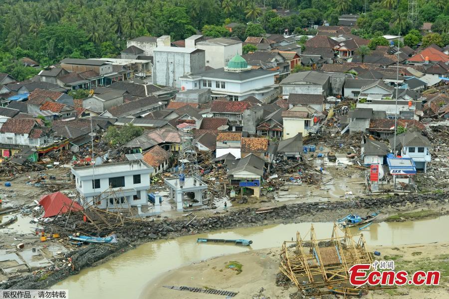 Damaged buildings are seen along a beach after a tsunami in Banten province, Indonesia, Dec. 26, 2018. Indonesia on Thursday raised the alert level for the erupting Anak Krakatau volcano to the second-highest, and ordered all flights to steer clear, days after it triggered a tsunami that killed at least 430 people. (Photo/Agencies)