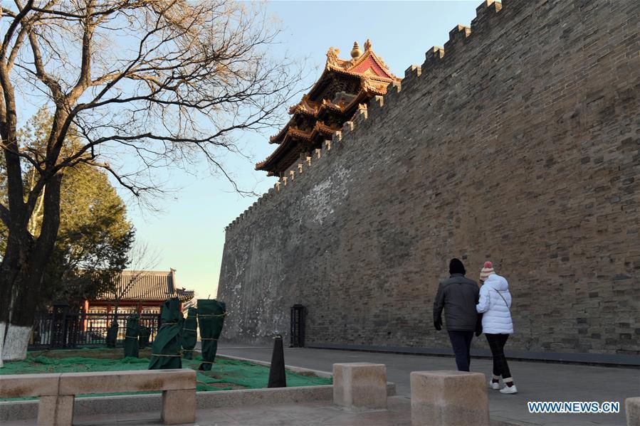 Tourists walk past the wall of the Palace Museum in Beijing, capital of China, Jan. 1, 2019. In order to further enhance visiting experiences and loosen pressure on exits, starting from Jan. 1, 2019, the museum will open the area between its northern Gate of Divine Prowess (Shenwu) and eastern Gate of East Glory (Donghua). (Xinhua/Jin Liangkuai)