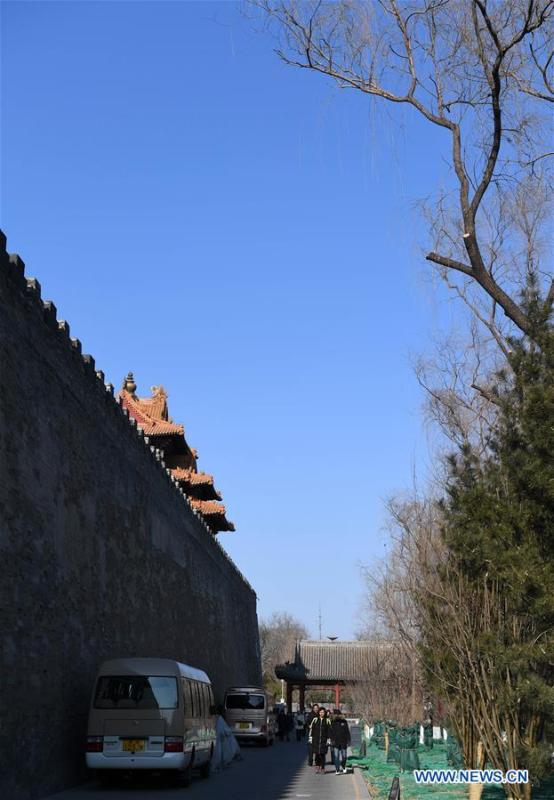 Tourists walk past the wall of the Palace Museum in Beijing, capital of China, Jan. 1, 2019. In order to further enhance visiting experiences and loosen pressure on exits, starting from Jan. 1, 2019, the museum will open the area between its northern Gate of Divine Prowess (Shenwu) and eastern Gate of East Glory (Donghua). (Xinhua/Jin Liangkuai)