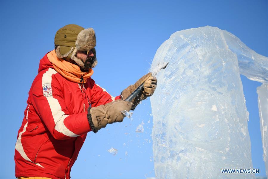 A contestant carves an ice sculpture during an international ice sculpture competition in Harbin, capital of northeast China\'s Heilongjiang Province, Jan. 2, 2019. A total of 16 teams from 12 countries and regions took part in the competition. (Xinhua/Wang Jianwei)