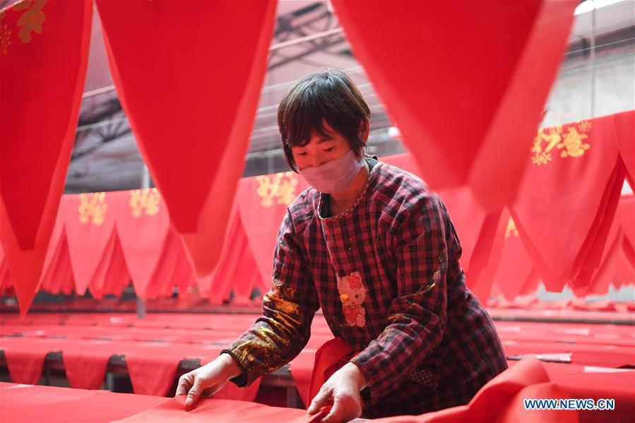 A villager works in a lantern workshop for the upcoming peak sales season of Spring Festival in Jifeng Town of Jishan County in Yuncheng, north China\'s Shanxi Province, Jan. 3, 2019. (Xinhua/Yang Chenguang)