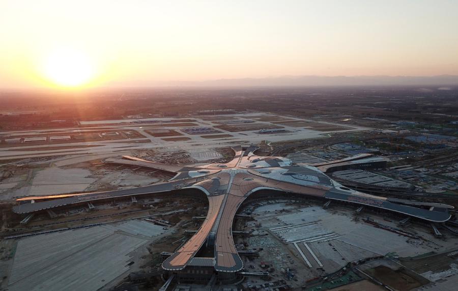 An aerial photo shows the construction site of Beijing\'s new airport in Daxing district in Beijing, Oct 2, 2018. (Photo/Xinhua)

Passengers traveling through Beijing Capital International Airport exceeded 100 million in 2018, according to the General Administration of Civil Aviation, which is close to its limit.

The administration predicted that passenger numbers through the capital will reach 150 million by 2025.

The new airport-with four runways and a 700,000 square meter terminal-will help to meet the demand and improve the global flight network. It is expected to be the world\'s largest.

The airport is designed to handle 72 million passengers, 20 million metric tons of cargo and mail, and 620,000 takeoffs and landings annually by 2025. There are long-term plans to expand the passenger number to 100 million annually.