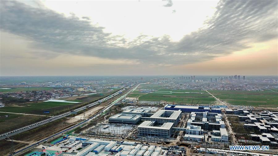 Aerial photo taken on March 29, 2018 shows the construction site of the Xiongan public services center in Xiongan New Area, north China\'s Hebei Province. China\'s central authorities have approved the 2018-2035 master plan for Xiongan New Area, stressing that its creation is significant to high-quality development and the building of the modern economic system. The plan was approved by the Central Committee of the Communist Party of China (CPC) and the State Council. The master plan is the fundamental guideline for the development, construction and management of the Xiongan New Area and should be strictly implemented, according to the approval released on Wednesday. The plan also lists overall development goals for the new area. By 2035, Xiongan will basically develop into a modern city that is green, intelligent and livable, with relatively strong competitiveness and harmonious human-environment interaction. (Xinhua/Mu Yu)