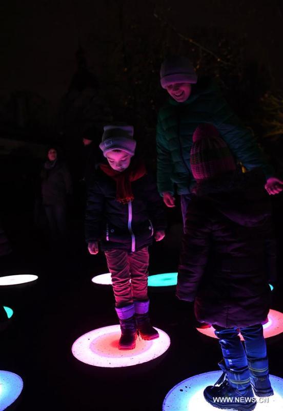 Children step on illuminated installations during China Light Festival at Cologne Zoo in Cologne, Germany, on Jan. 3, 2019. The festival is held here presenting more than 50 lights from Dec. 8, 2018 to Jan. 20, 2019. (Xinhua/Lu Yang)