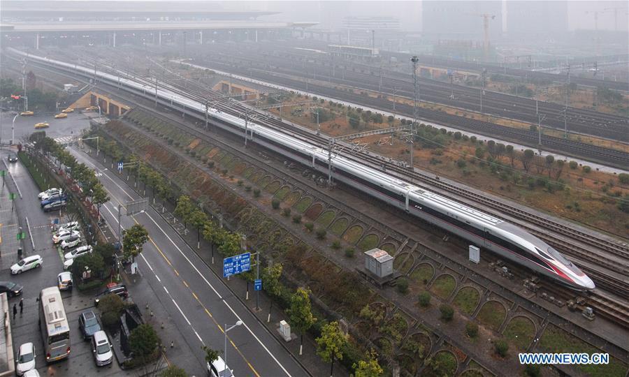 Photo taken on Jan. 5, 2019 shows a new Fuxing bullet train running on the Beijing-Shanghai line arriving at Nanjing South Railway Station in Nanjing, east China\'s Jiangsu Province. A longer Fuxing bullet train started running on the Beijing-Shanghai line Saturday at noon. The new train, with a designed speed of 350 km per hour, has 17 carriages, one carriage longer than the Fuxing trains currently in use. (Xinhua/Su Yang)
A longer Fuxing bullet train started running on the Beijing-Shanghai line Saturday at noon.
The new train, with a designed speed of 350 km per hour, has 17 carriages, one carriage longer than the Fuxing trains currently in use.
Measuring 439.9 meters long and with a seating capacity of 1,283 people, the 17-carriage train can be used with existing stations, platforms and other high-speed railway facilities.
The Fuxing bullet trains first made its debut in June 2017, and the 16-carriage trains were put into operation in July 2018.
Entirely designed and manufactured in China, the Fuxing, or Rejuvenation, trains are more spacious and energy-efficient, with a longer service life and better reliability than previous models.