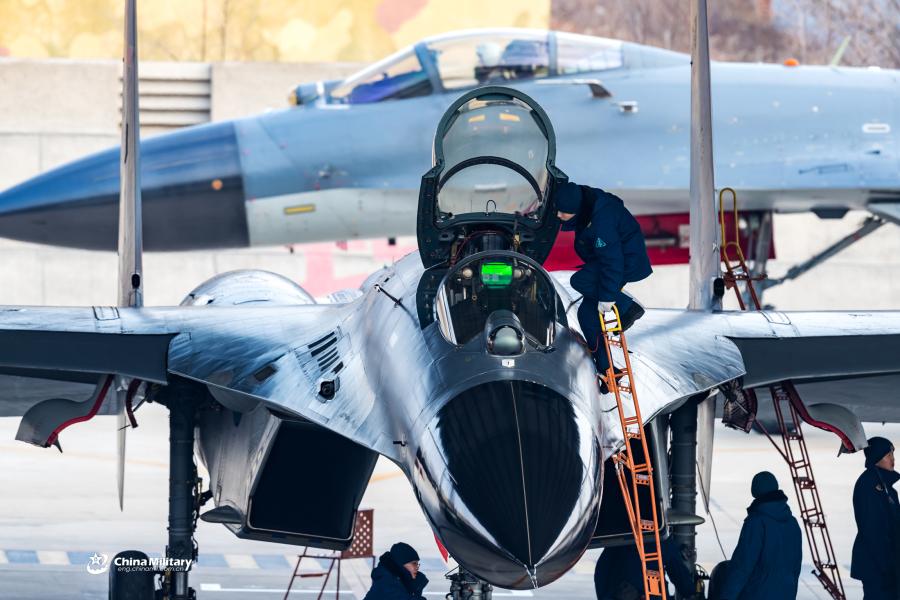 Maintenance men assigned to an aviation brigade of the air force with the PLA Northern Theater Command perform pre-flight inspections on a J-11B fighter jet prior to a round-the-clock flight training exercise on January 3, 2019. (Photo/eng.chinamil.com.cn)