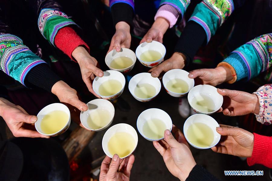 Villagers drink wine to wish for good luck during a get-together in Rongshui, Liuzhou City of south China\'s Guangxi Zhuang Autonomous Region, Jan. 5, 2019. Local Miao people celebrated their traditional New Year in various ways. (Xinhua/Huang Xiaobang)