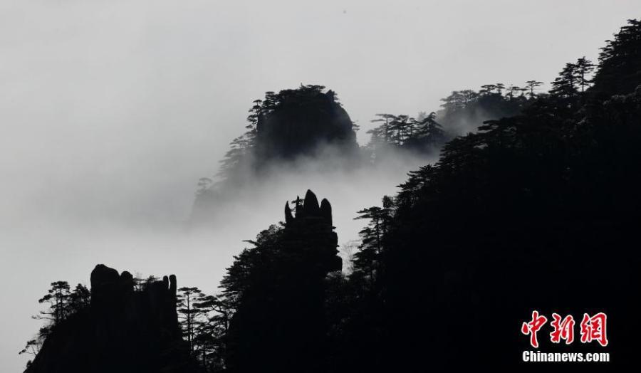 A sea of clouds after rain sweeps over Mount Huangshan in Anhui Province on Jan. 6, 2018. A UNESCO World Heritage site, the area is well known for its scenery, sunsets, peculiarly-shaped granite peaks, and pine trees. (Photo: China News Service/Shi Guangde)