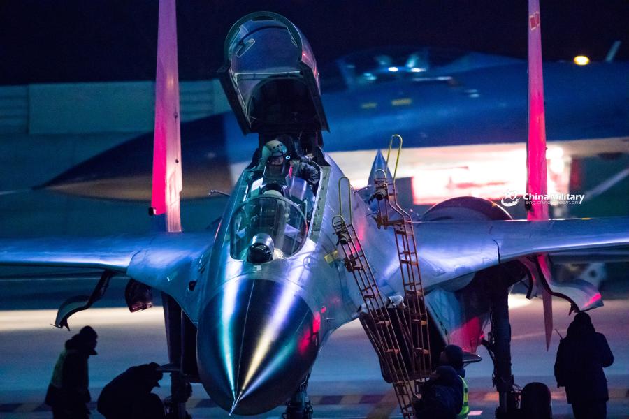 Pilots assigned to an aviation brigade of the air force with the PLA Northern Theater Command finish one-day training courses and prepare to climb down ladders from the cockpit of a J-11B fighter jet after a round-the-clock flight training exercise on January 3, 2019.  (Photo/eng.chinamil.com.cn)