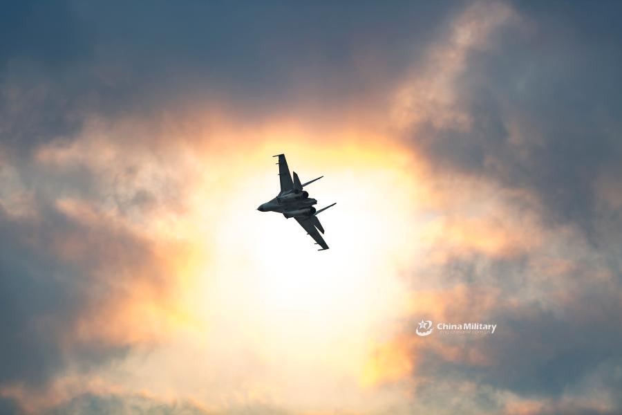 A J-11B fighter jet attached to an aviation brigade of the air force with the PLA Northern Theater Command flies past the sun during a round-the-clock flight training exercise on January 3, 2019. (Photo/eng.chinamil.com.cn)