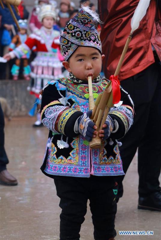 A boy of Miao ethnic group plays Lusheng in Rongshui, Liuzhou City of south China\'s Guangxi Zhuang Autonomous Region, Jan. 5, 2019. Local Miao people celebrated their traditional New Year in various ways. (Xinhua/Long Linzhi)