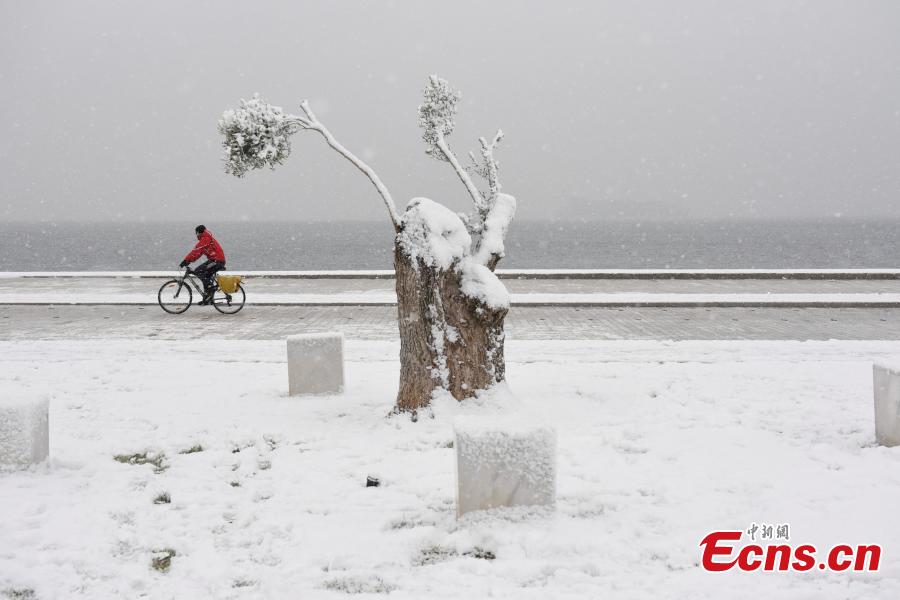 A man rides his bike during snowfall at the seaside promenade of Thessaloniki, Greece, Jan. 4, 2019. An elderly woman was found dead and two men were missing after blizzards hit parts of Greece, police officials said on Saturday. (Photo/Agencies)