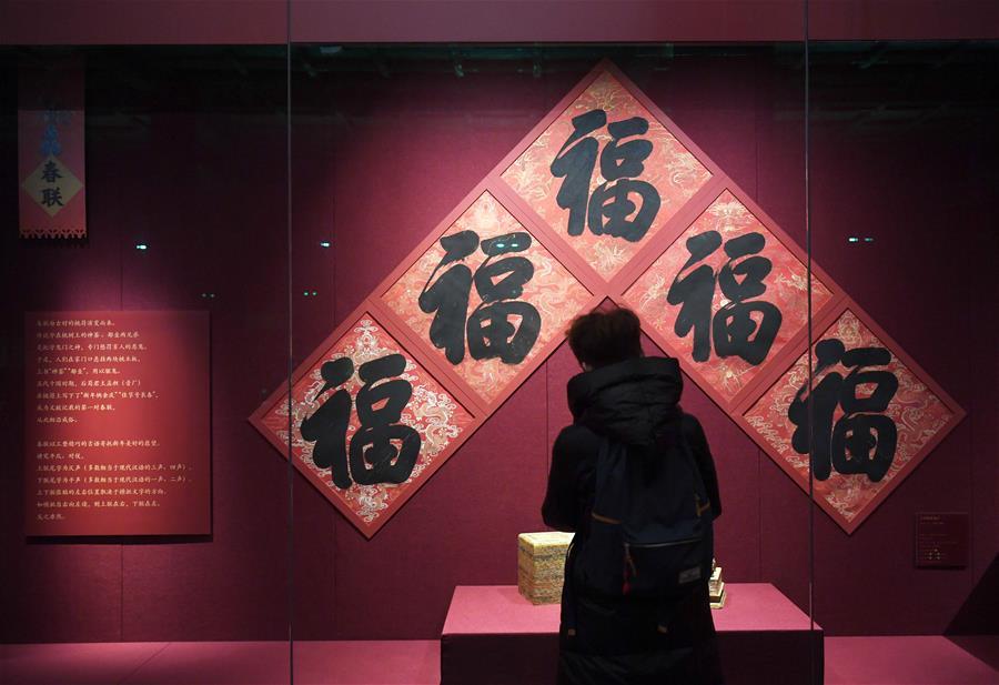 A tourist looks at exhibits displayed at the Palace Museum, also known as the Forbidden City in Beijing, capital of China, Jan. 7, 2019. In celebrating of the most magnificent of all traditional holidays, the Palace Museum presents exhibition of \