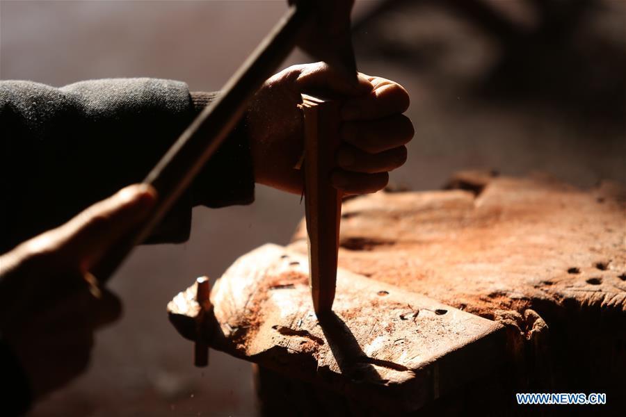 Villager Gao Zhenbao makes parts of Erhu, a Chinese two-stringed bowed instrument at Yuequan Village of Miaoshan Town in Linyi City, east China\'s Shandong Province, Jan. 8, 2019. Yuequan is famous for its time-honored handmade Erhu, with more than 90 households dedicated to it in the village. (Xinhua/Zhang Chunlei)