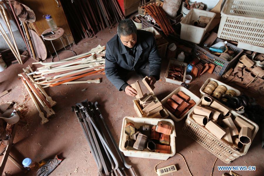 Villager Gao Zhenbao checks parts of Erhu, a Chinese two-stringed bowed instrument at Yuequan Village of Miaoshan Town in Linyi City, east China\'s Shandong Province, Jan. 8, 2019. Yuequan is famous for its time-honored handmade Erhu, with more than 90 households dedicated to it in the village. (Xinhua/Zhang Chunlei)