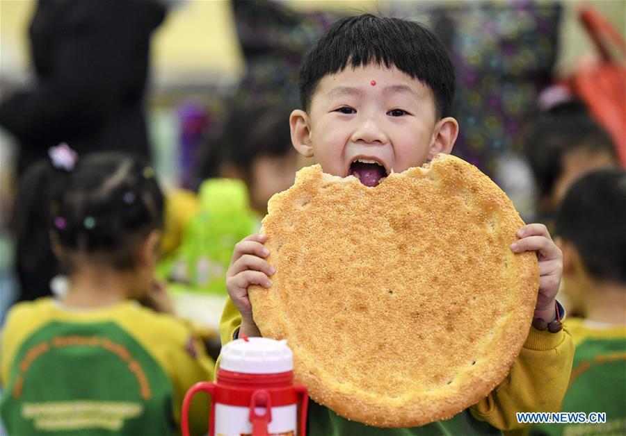 A kid takes a bite of \