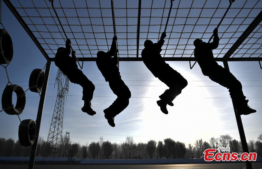 Members of the special police force of Urumqi City, Northwest China\'s Xinjiang Uygur Autonomous Region, undergo an intensive training at a snow field in freezing conditions, Jan. 9, 2019. The 60-plus day winter training included running, the use of police equipment and combat skills. (Photo: China News Service/Liu Xin)