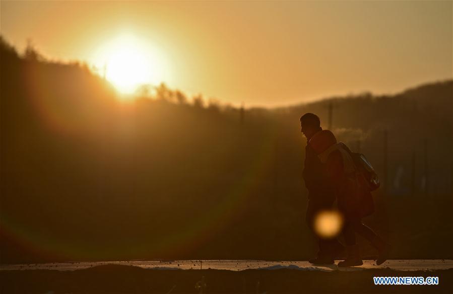 Hu Zhisheng and his student Sun Xiaofeng walk to school in Yantai Village of Lianhua Township in Tieling City, northeast China\'s Liaoning Province, Jan. 8, 2019. Located in a remote mountain village, most students of Yantai school had transferred to other places outside the mountain. Sun Xiaofeng, a third grade student, became the only student of the school in September last year taught by Hu Zhisheng, the only one faculty of Yantai primary school. (Xinhua/Yao Jianfeng)
