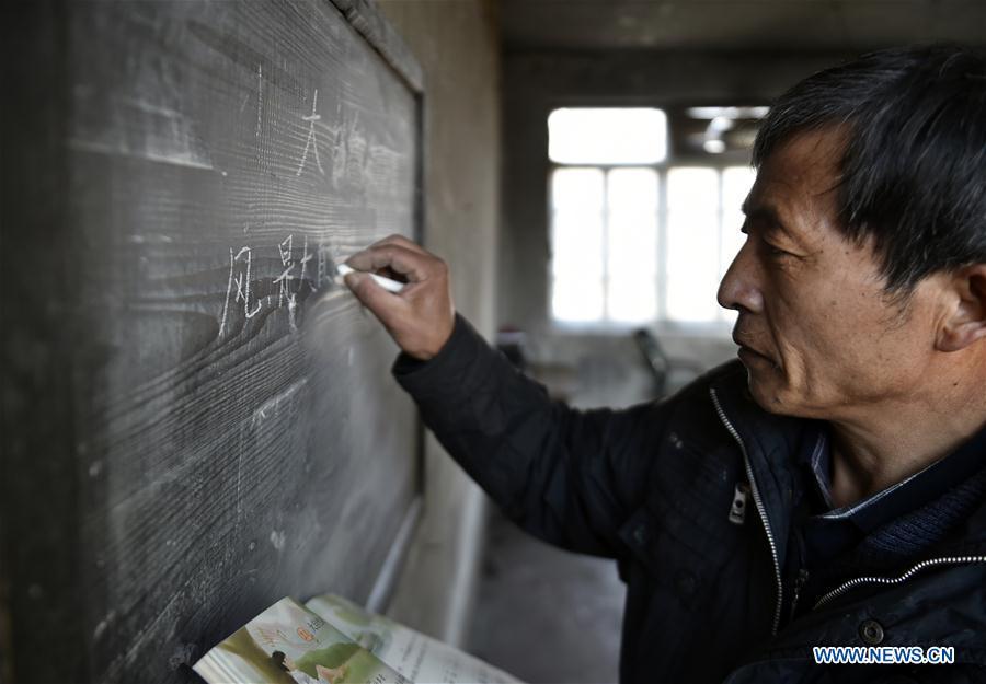 Hu Zhisheng writes on the blackboard at Yantai primary school in Yantai Village of Lianhua Township in Tieling City, northeast China\'s Liaoning Province, Jan. 7, 2019. Located in a remote mountain village, most students of Yantai school had transferred to other places outside the mountain. Sun Xiaofeng, a third grade student, became the only student of the school in September last year taught by Hu Zhisheng, the only one faculty of Yantai primary school. (Xinhua/Yao Jianfeng)