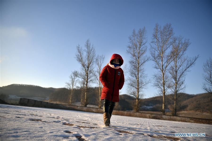 Sun Xiaofeng walks on the snow on the playground before classes at Yantai primary school in Yantai Village of Lianhua Township in Tieling City, northeast China\'s Liaoning Province, Jan. 8, 2019. Located in a remote mountain village, most students of Yantai school had transferred to other places outside the mountain. Sun Xiaofeng, a third grade student, became the only student of the school in September last year taught by Hu Zhisheng, the only one faculty of Yantai primary school. (Xinhua/Yao Jianfeng)