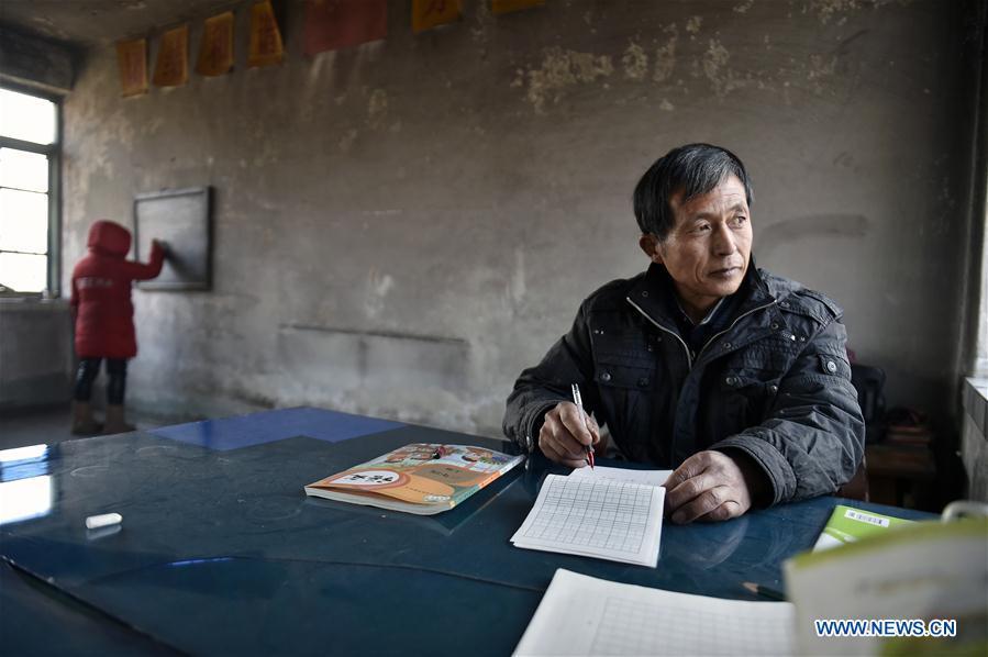Hu Zhisheng and his student Sun Xiaofeng are seen at Yantai primary school in Yantai Village of Lianhua Township in Tieling City, northeast China\'s Liaoning Province, Jan. 7, 2019. Located in a remote mountain village, most students of Yantai school had transferred to other places outside the mountain. Sun Xiaofeng, a third grade student, became the only student of the school in September last year taught by Hu Zhisheng, the only one faculty of Yantai primary school. (Xinhua/Yao Jianfeng)