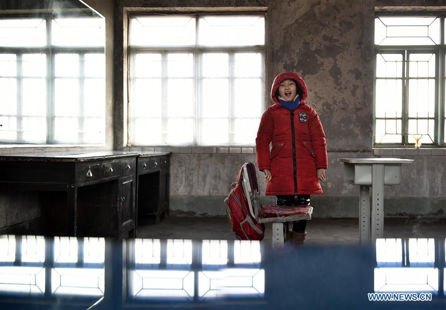 Sun Xiaofeng smiles after school at Yantai school in Yantai Village of Lianhua Township in Tieling City, northeast China\'s Liaoning Province, Jan. 7, 2019. Located in a remote mountain village, most students of Yantai school had transferred to other places outside the mountain. Sun Xiaofeng, a third grade student, became the only student of the school in September last year taught by Hu Zhisheng, the only one faculty of Yantai primary school. (Xinhua/Yao Jianfeng)