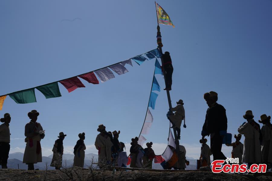 Tibetans hang prayer flags as part of celebrations for the New Year in the Tibetan calendar in Nyemo County, Southwest China\'s Tibet Autonomous region. In traditional highland barley farming areas, including Nyemo County, locals have a tradition of celebrating the Tibetan New Year one month early, so the celebrations do not affect farming. (Photo: China News Service/Sangdan Pingcuo)