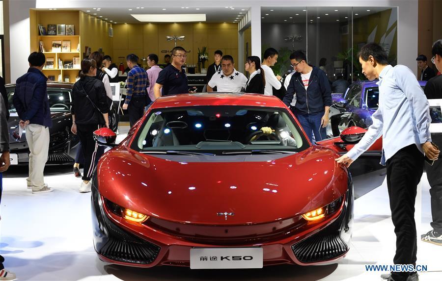Visitors view a car from Chinese electric automaker Qiantu at Haikou New Energy Vehicle Exhibition in Haikou, south China\'s Hainan Province, Jan. 10, 2019. A total of 197 new energy vehicles were displayed at the exhibition. (Xinhua/Yang Guanyu)