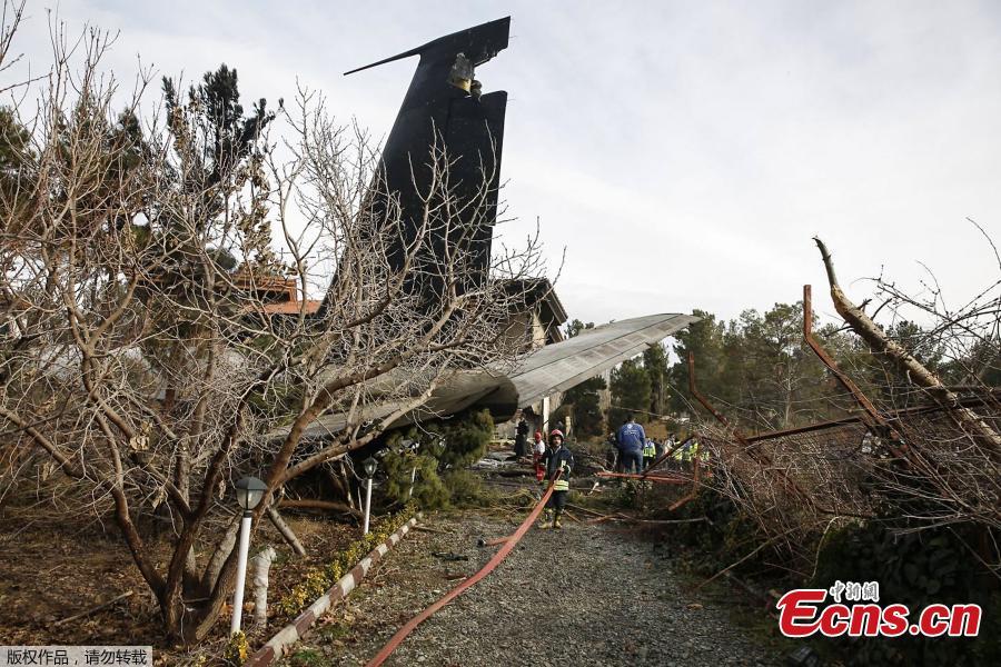 People, firefighters and security forces gather amid the debris of a Boeing 707 cargo plane that reportedly crashed into a residential complex near the Iranian capital Tehran with more than 10 people onboard on January 14, 2019. The plane overshot the runway during its landing, Iran\'s aviation organisation spokesman Reza Jafarzadeh told state broadcaster IRIB. (Photo/Agencies)
