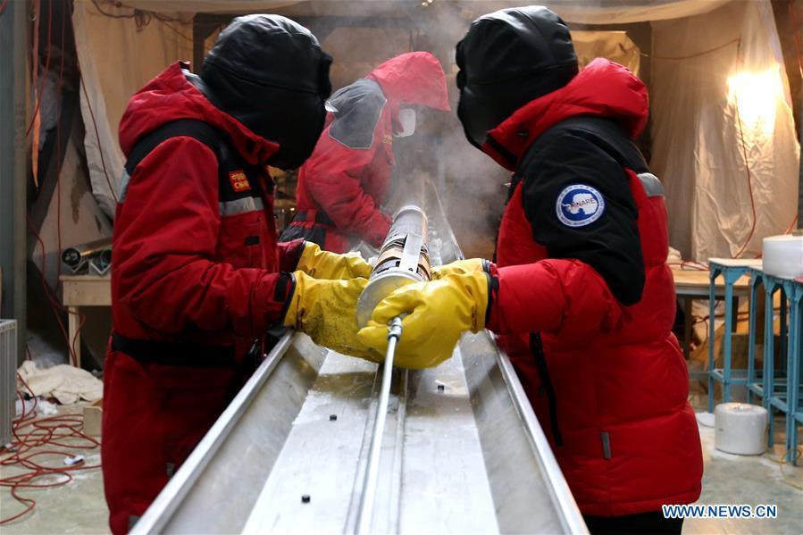 Members of one of two inland expedition teams on China\'s 35th Antarctic expedition handle the newly-drilled ice core at the Kunlun Station in Antarctica, Jan. 12, 2019. (Xinhua/Liu Shiping)