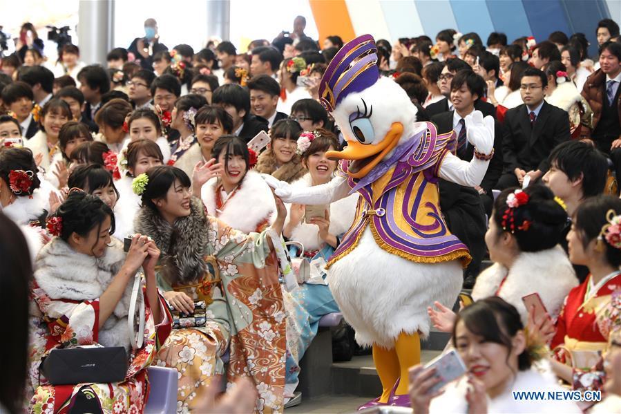 Japanese boys and girls celebrate Coming of Age with a Disney character at Tokyo Disneyland in Chiba, Japan, Jan. 14, 2019. People who turned 20-year-old took part in the annual Coming of Age Day ceremony in Japan on Monday. (Xinhua/Du Xiaoyi)