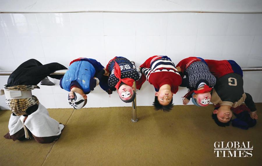 Students arch their backs during a Peking Opera training session at the Xichang Primary School.  (Photos: Yang Hui/GT)