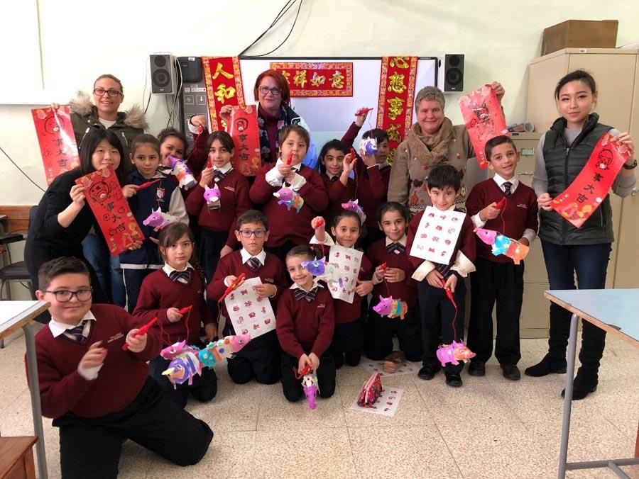 Students make pig-themed paper art at a primary school in Kalkara, Malta, on Jan. 10, 2019. (Photo/Chinaculture.org)