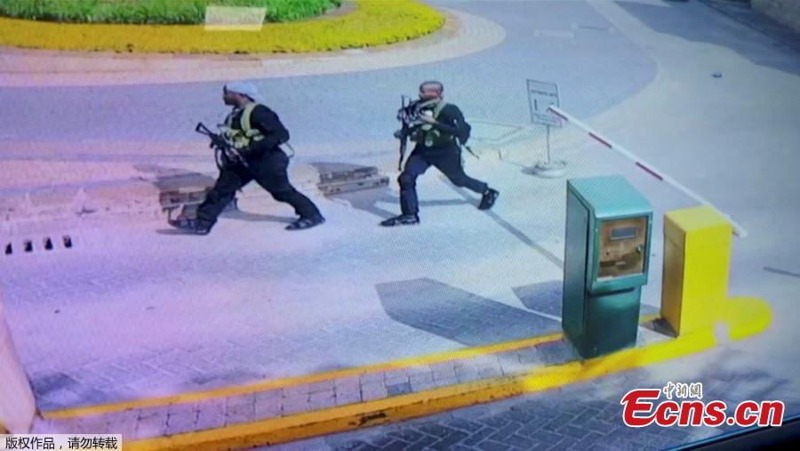 Heavily armed attackers walk through the Nairobi hotel compound in this grab taken from security camera footage released to the local media. Kenyan security forces have killed all the Somali militants who stormed an upscale Nairobi hotel compound, taking at least 21 lives and forcing hundreds of people into terrifying escapes, the government said on Wednesday. (Photo/Agencies)