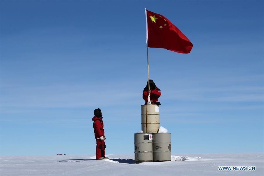 A member of China\'s 35th Antarctic expedition team erects the Chinese national flag at the area of the Dome Argus (Dome A), the peak of Antarctica\'s inland icecap, in Antarctica, Jan. 16, 2019. (Xinhua/Liu Shiping)