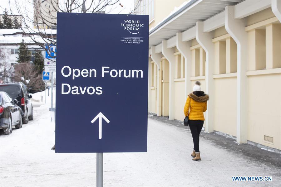 A woman passes by a sign of the World Economic Forum (WEF) in Davos, Switzerland, Jan. 21, 2019. The WEF Annual Meeting will kick off in Davos on Tuesday. (Xinhua/Xu Jinquan)