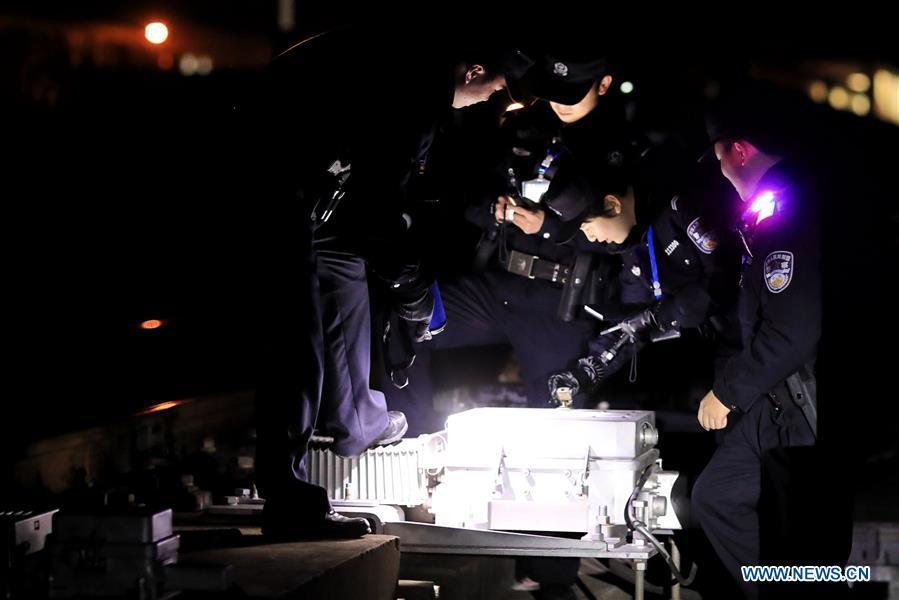 Policemen check the operation of the facilities along the high-speed railway in Rongjiang County, southwest China\'s Guizhou Province, Jan. 22, 2019. Rongjiang Railway Police Station conducts two or three safety inspections at night every week during the Spring Festival travel rush. (Xinhua/Ou Dongqu)